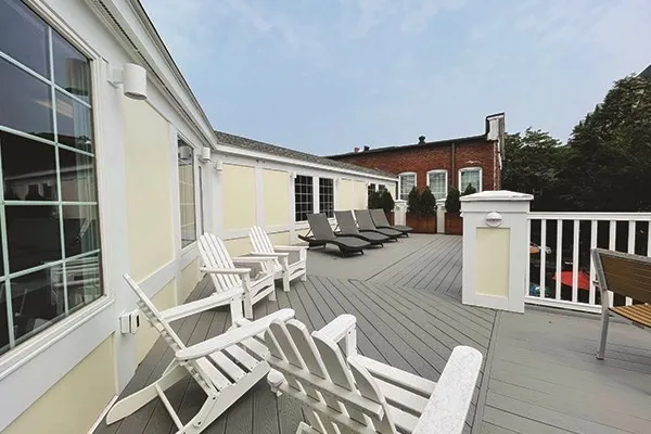 a view of a patio with table and chairs and wooden floor