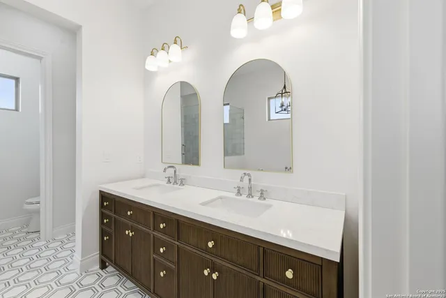 a bathroom with a double vanity sink and a mirror