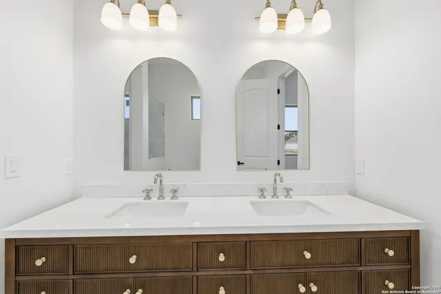 a bathroom with a double vanity sink and a mirror