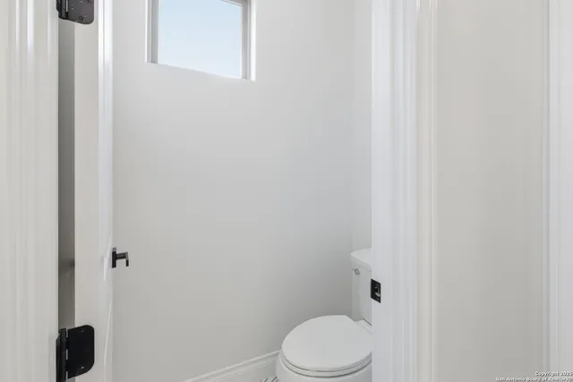 a white toilet sitting next to a shower
