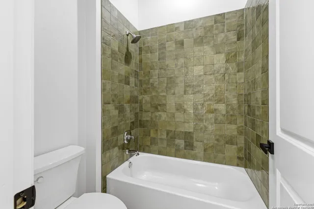 a bathroom with a shower and a toilet