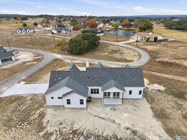 an aerial view of a house with a yard big and large tree