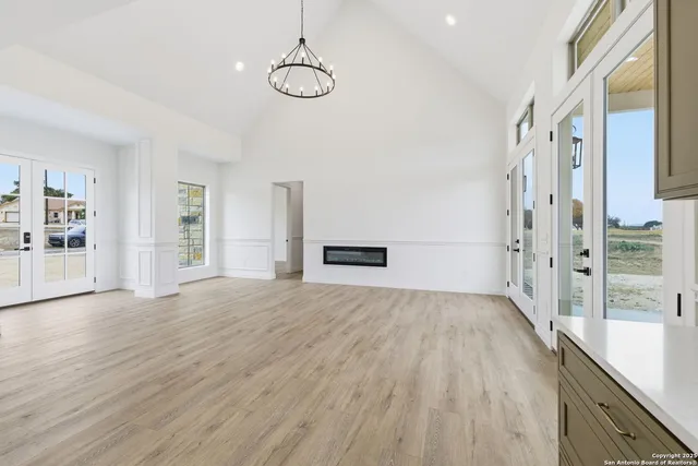 a view of empty room with wooden floor and stove