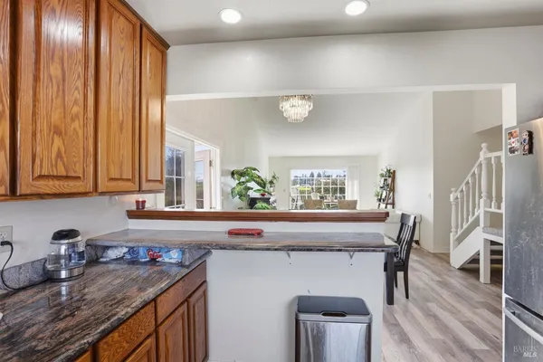 a kitchen with a sink a microwave cabinets and outdoor space