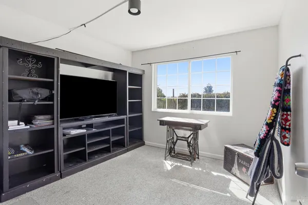 a view of a workspace with furniture and natural light