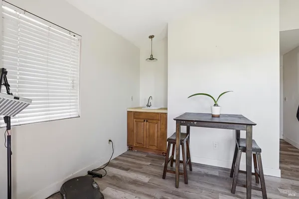 a view of a workspace with furniture and wooden floor