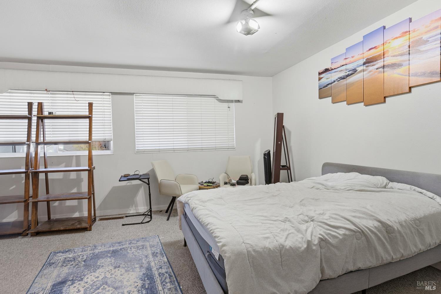 1407 Georgia Court Rohnert Park, CA 94928 - Photo 25 of 36 a bedroom with a bed and a painting on the wall