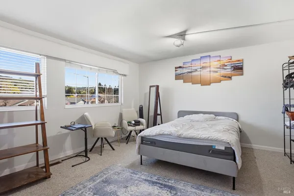 a bedroom with a bed and dresser with mirror