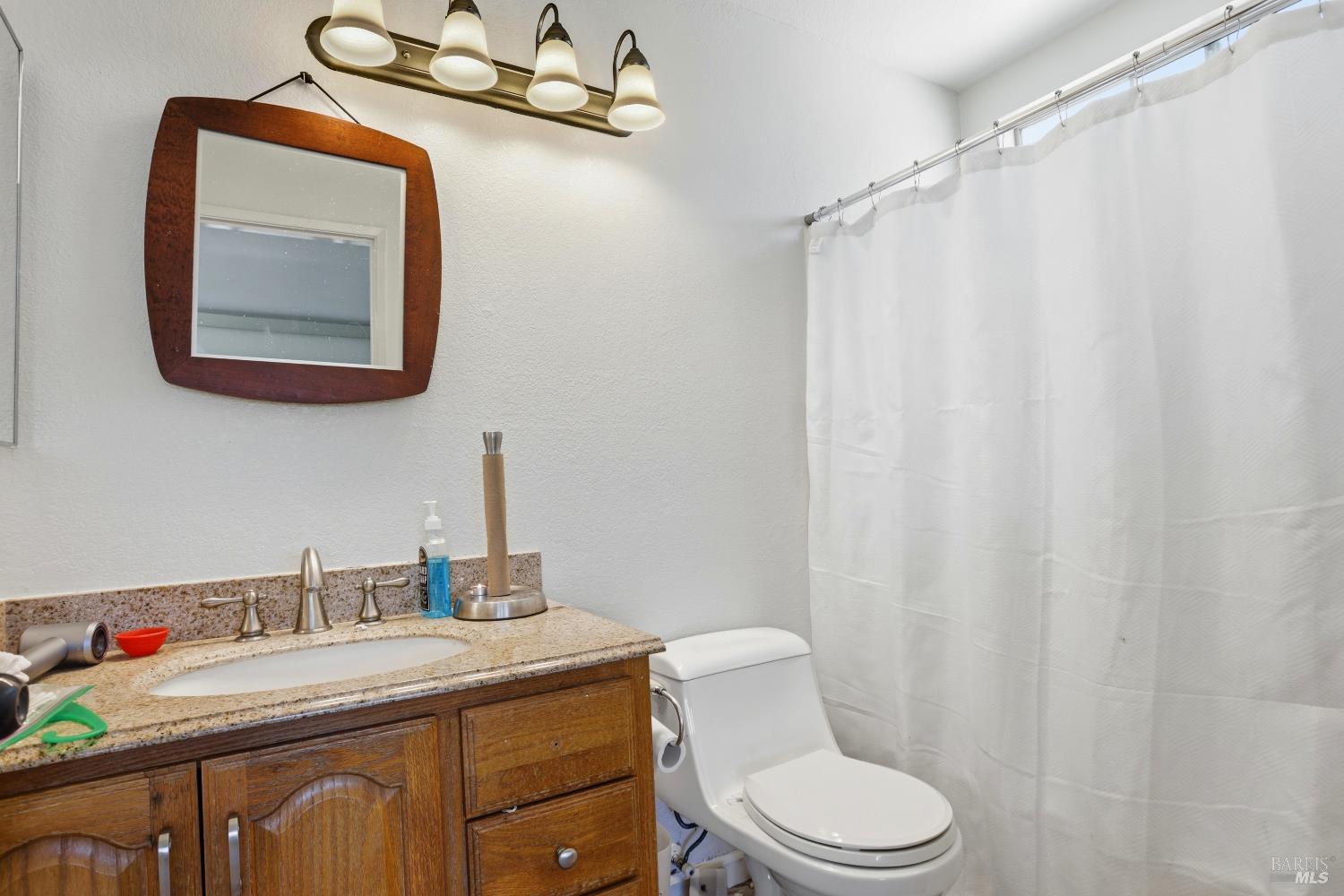 1407 Georgia Court Rohnert Park, CA 94928 - Photo 30 of 36 a bathroom with a sink vanity mirror and toilet