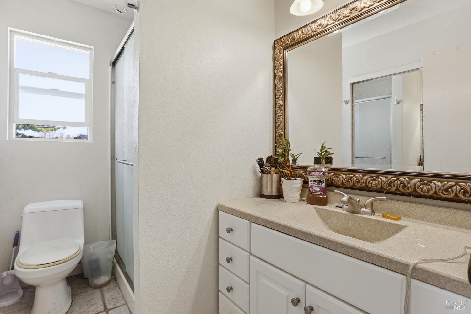 1407 Georgia Court Rohnert Park, CA 94928 - Photo 31 of 36 a bathroom with a toilet sink and mirror