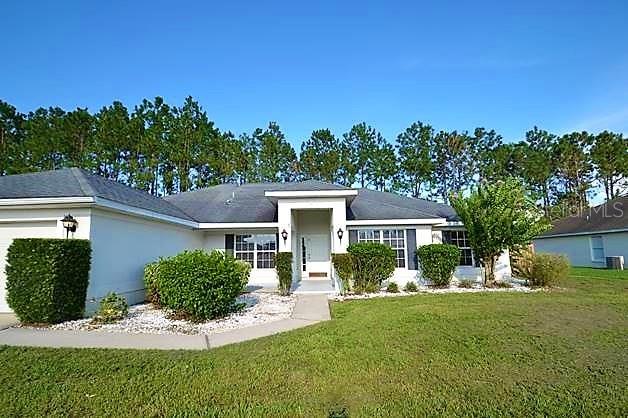 309 Towhee Road Winter Haven, FL 33881 - Photo 1 of 1 a front view of a house with a yard