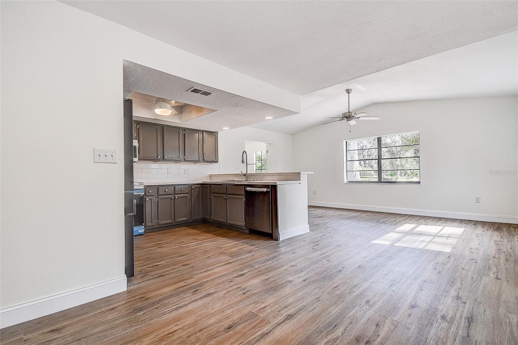 6234 Neff Lake Road Brooksville, FL 34601 - Photo 12 of 59 a view of kitchen and sink with wooden floor