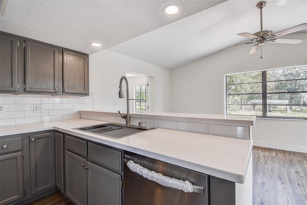 6234 Neff Lake Road Brooksville, FL 34601 - Photo 16 of 59 a kitchen with a sink cabinets and window
