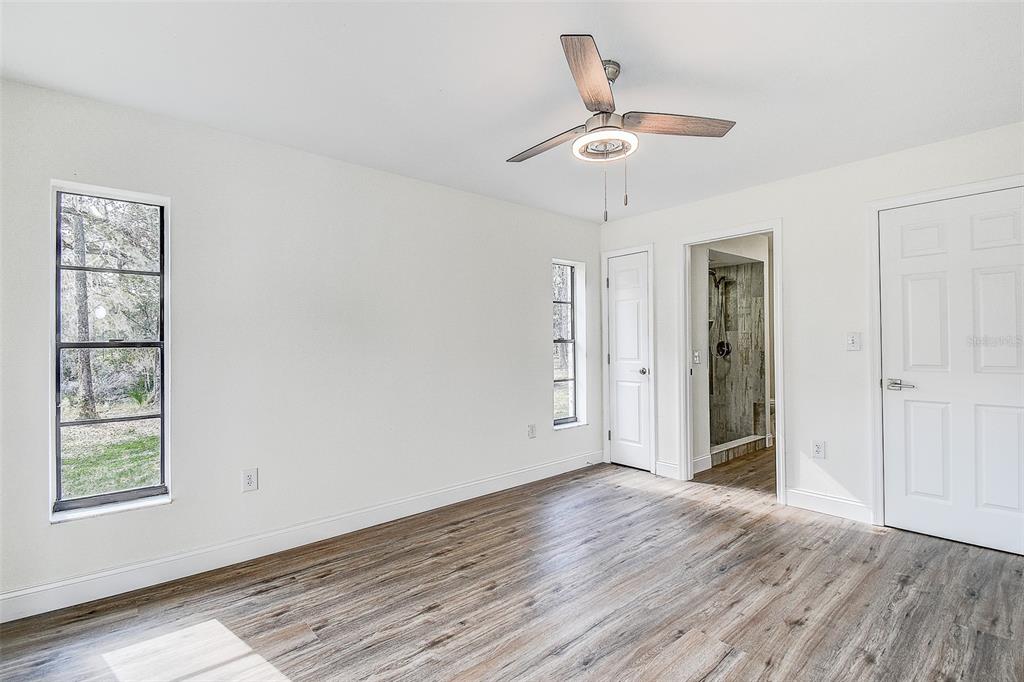 6234 Neff Lake Road Brooksville, FL 34601 - Photo 17 of 59 wooden floor in an empty room with a window