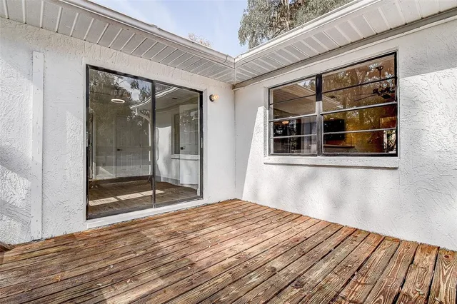 a view of a terrace with wooden floor and fence