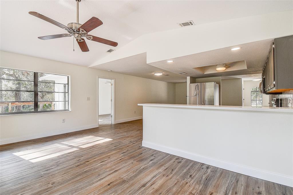 6234 Neff Lake Road Brooksville, FL 34601 - Photo 25 of 59 a view of an empty room with wooden floor and a window