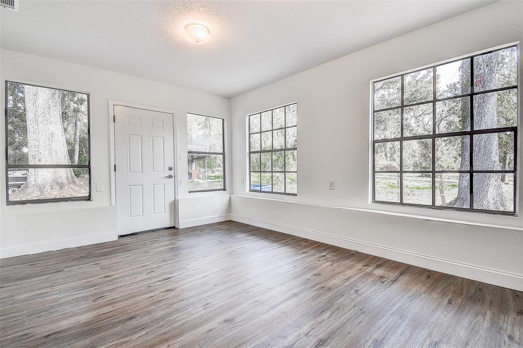 6234 Neff Lake Road Brooksville, FL 34601 - Photo 28 of 59 a view of an empty room with wooden floor and a window