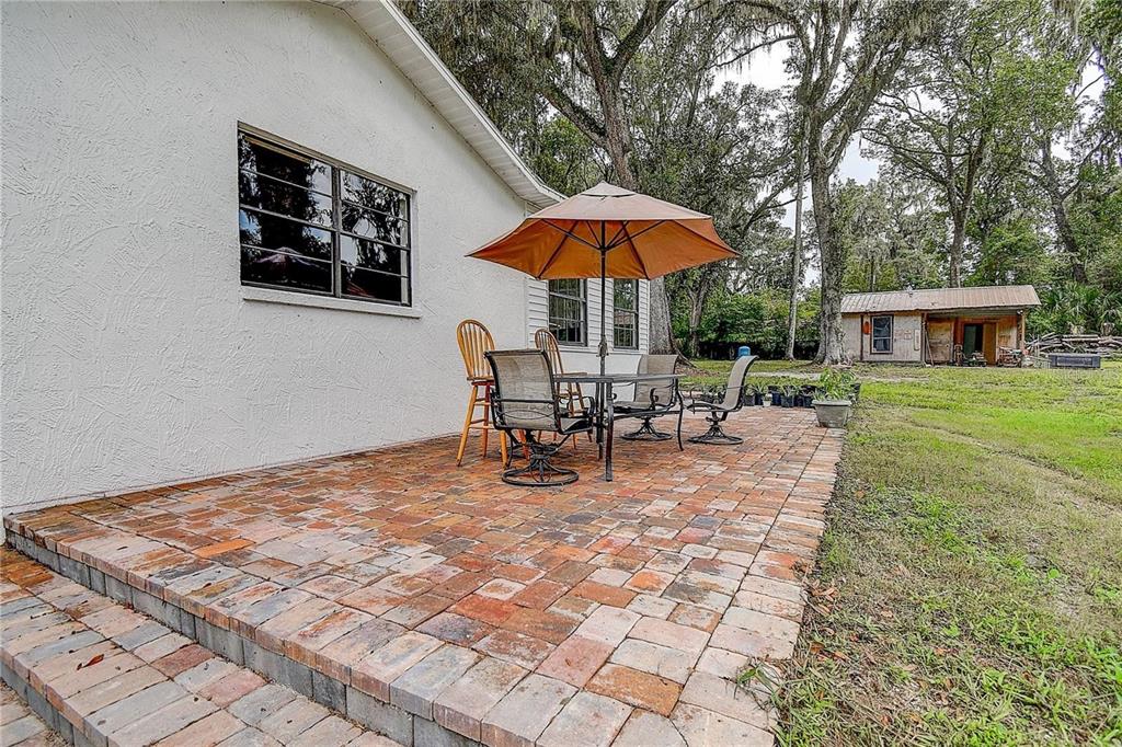 6234 Neff Lake Road Brooksville, FL 34601 - Photo 30 of 59 a view of a house with backyard porch and furniture