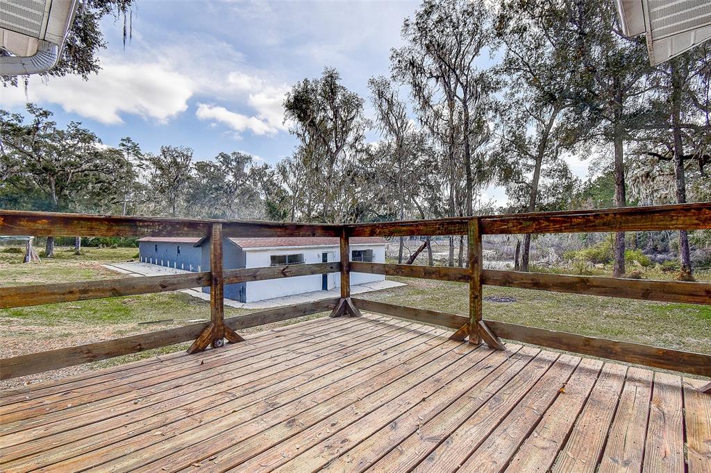 6234 Neff Lake Road Brooksville, FL 34601 - Photo 33 of 59 a view of a terrace with wooden floor and fence