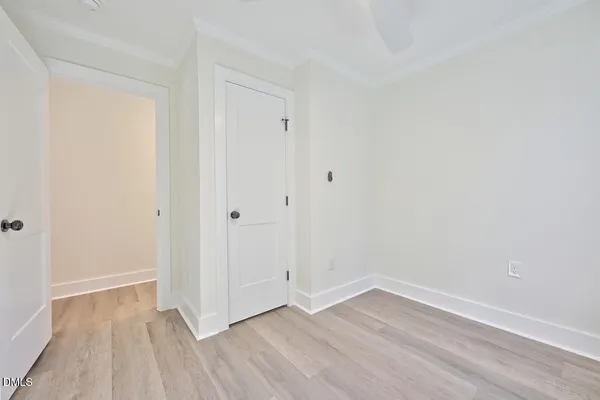 a view of an empty room with wooden floor