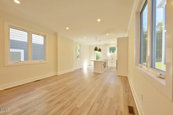 a view of a room with wooden floor and white walls