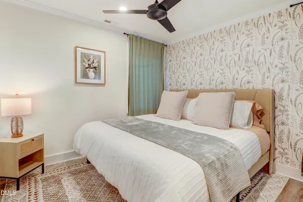 a view of a bathroom with wooden floor and a window