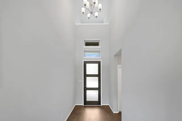 a view of an entryway with wooden floor and front door