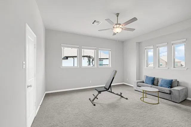 a view of a livingroom with furniture and windows