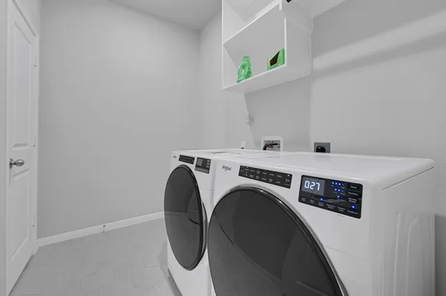 a bedroom with two beds and a large window