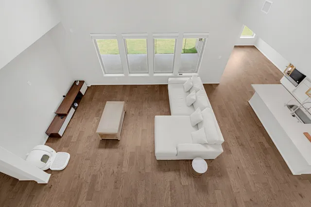 wooden floor with view of living room