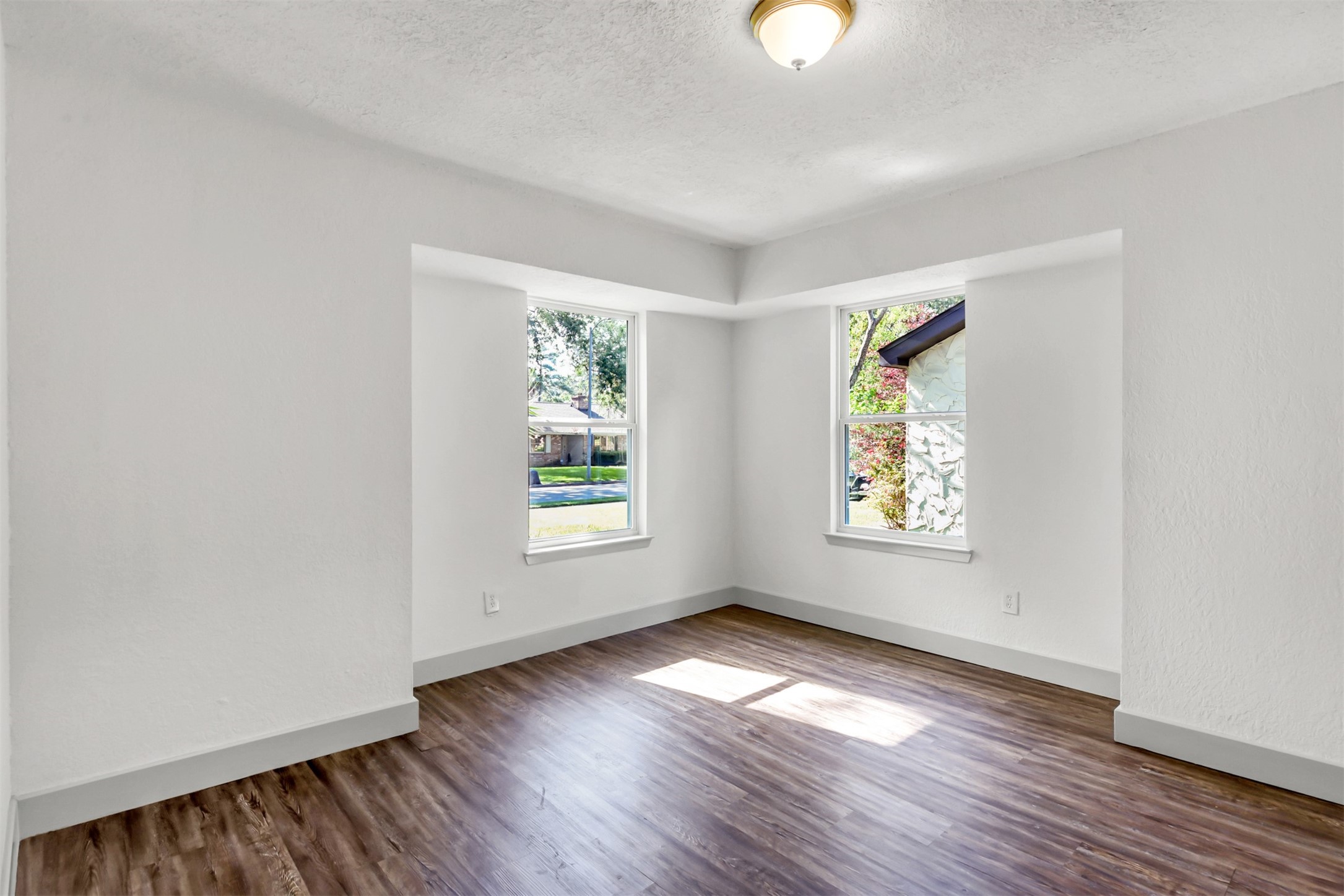 23118 Whispering Willow Drive Spring, TX 77373 - Photo 13 of 37 an empty room with wooden floor and windows