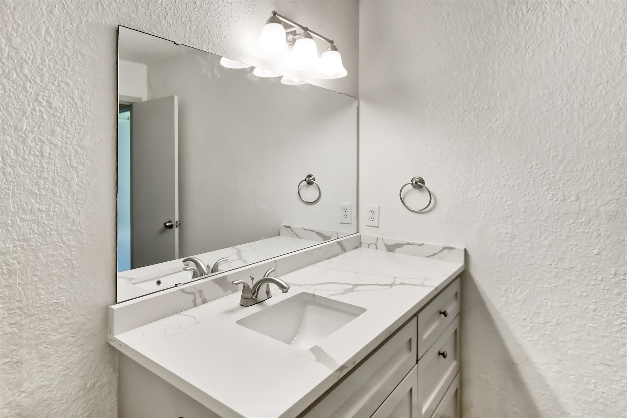 23118 Whispering Willow Drive Spring, TX 77373 - Photo 17 of 37 a bathroom with a sink and a mirror