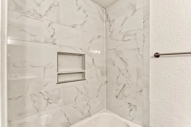 a bathroom with a toilet sink and shower