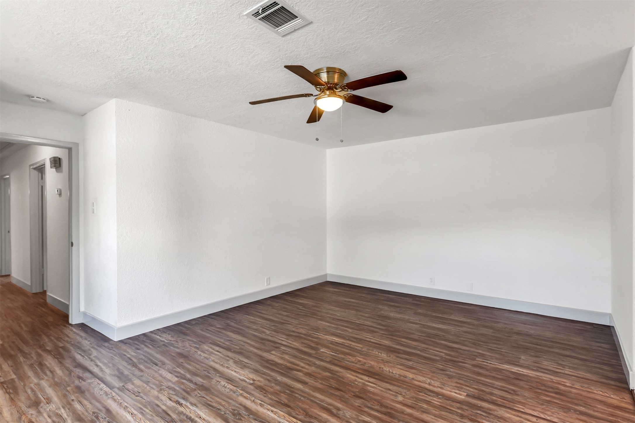 23118 Whispering Willow Drive Spring, TX 77373 - Photo 21 of 37 an empty room with wooden floor a ceiling fan and windows
