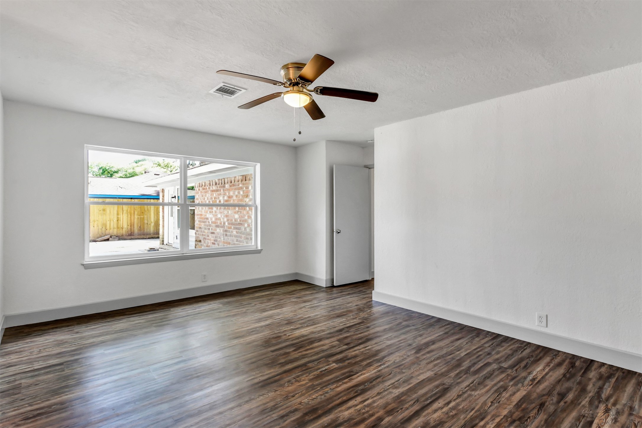 23118 Whispering Willow Drive Spring, TX 77373 - Photo 24 of 37 a view of an empty room with wooden floor and a window