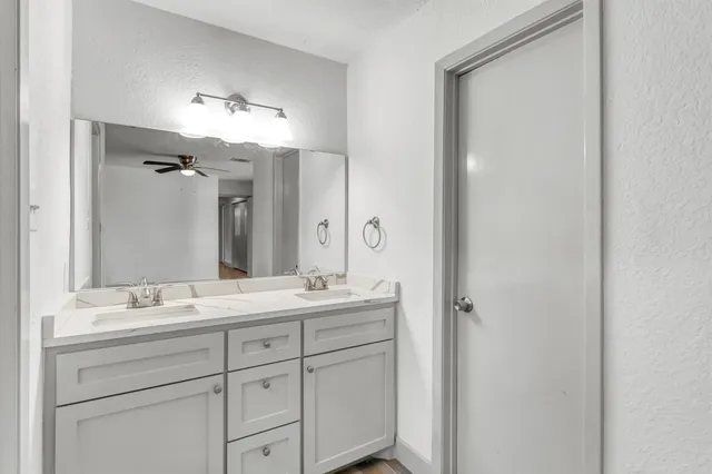 a bathroom with a double vanity sink and mirror