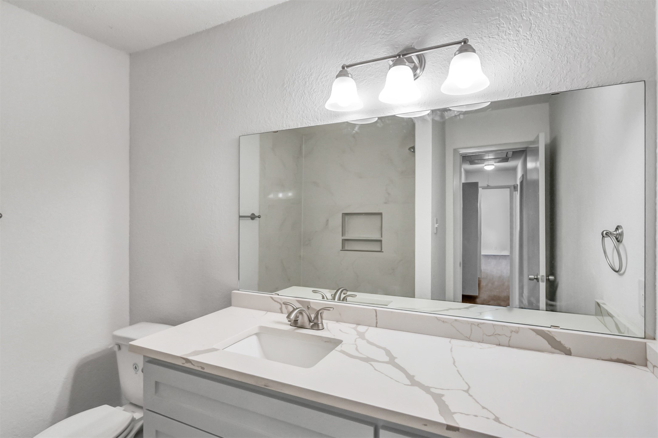 23118 Whispering Willow Drive Spring, TX 77373 - Photo 28 of 37 a bathroom with a sink a toilet and a mirror