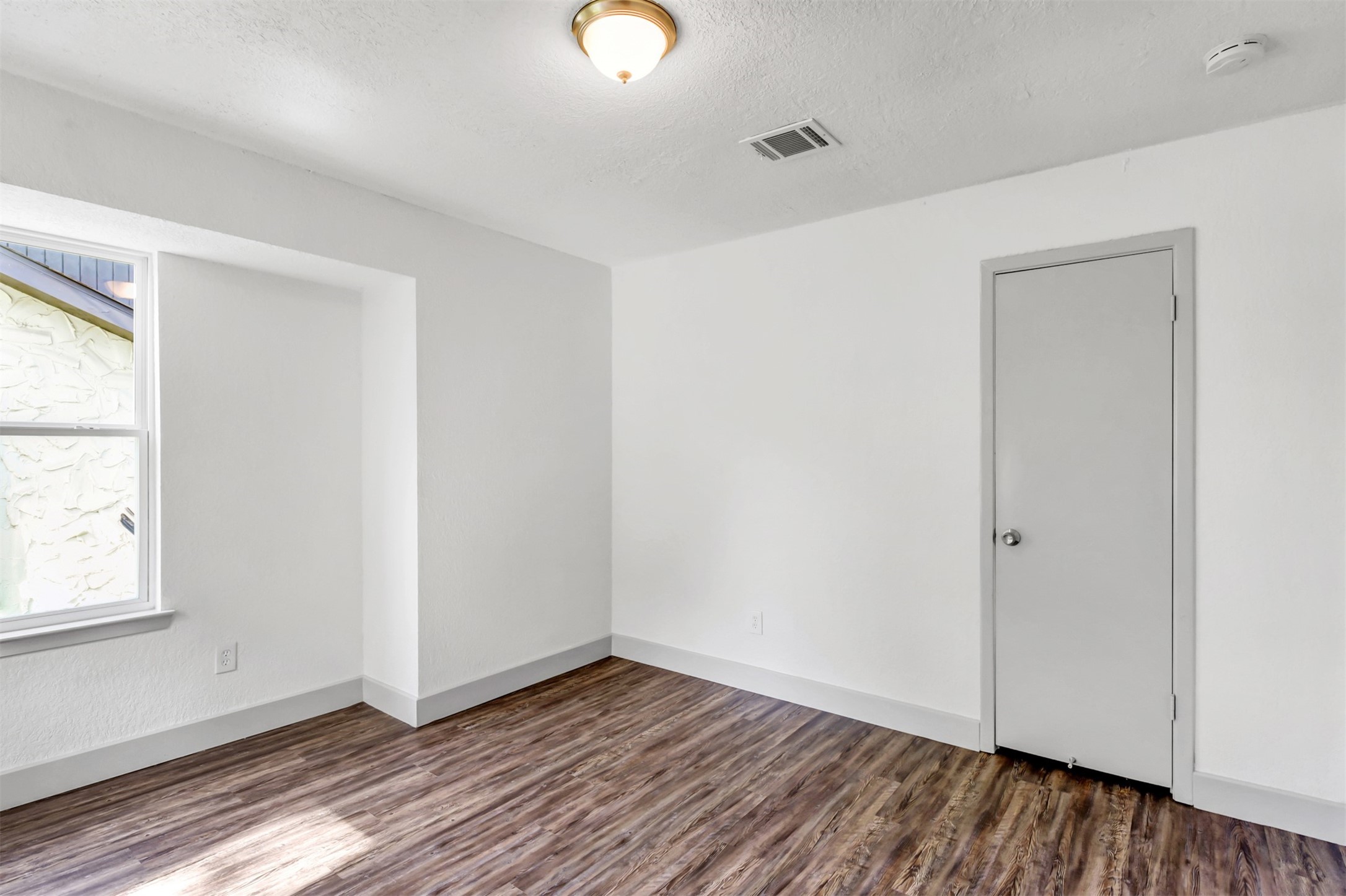 23118 Whispering Willow Drive Spring, TX 77373 - Photo 30 of 37 an empty room with wooden floor and windows