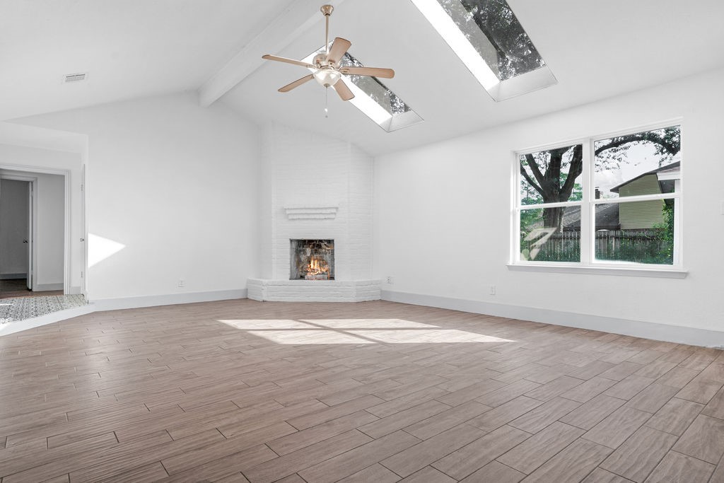 23118 Whispering Willow Drive Spring, TX 77373 - Photo 6 of 37 an empty room with wooden floor chandelier and windows