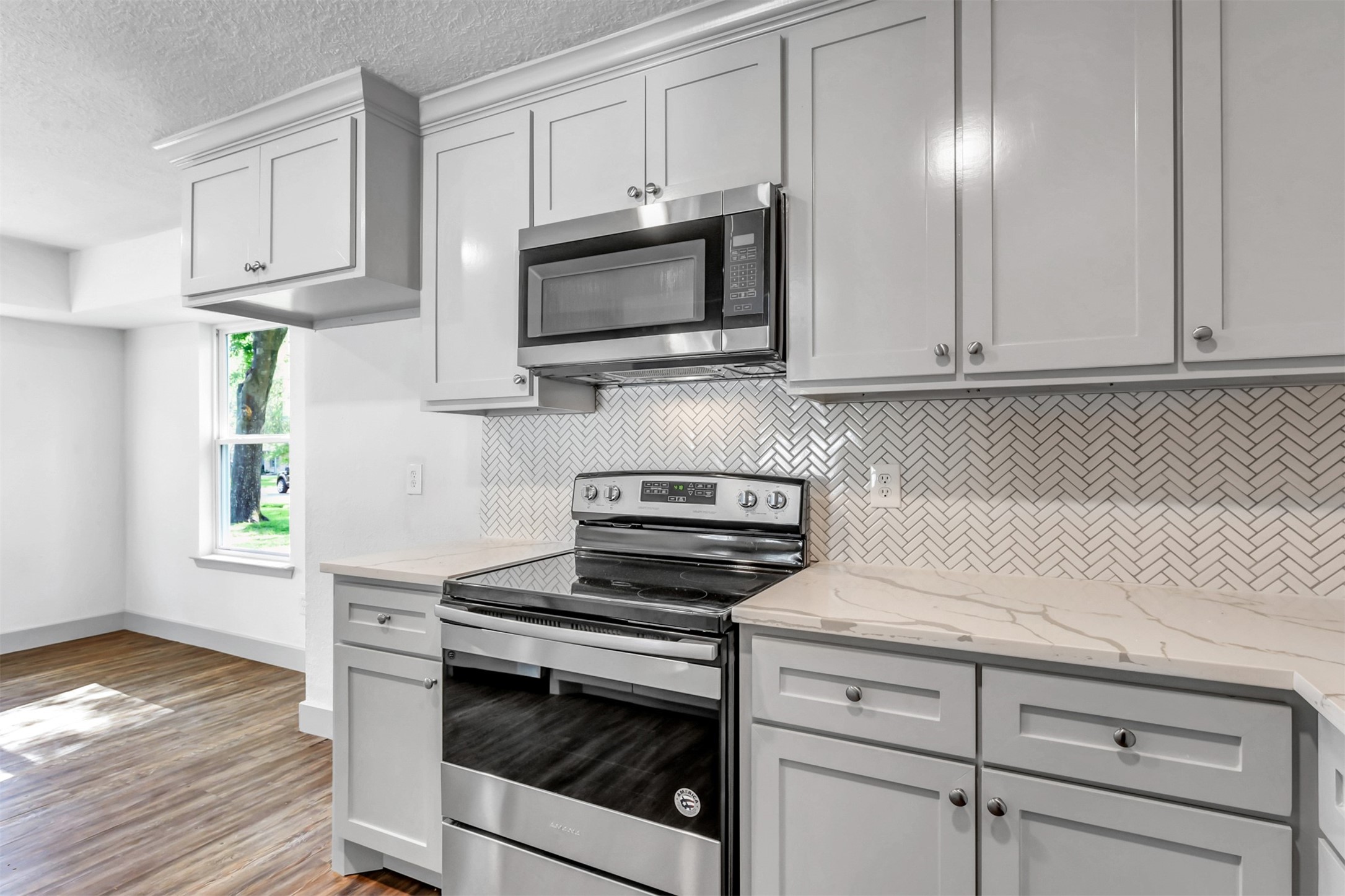 23118 Whispering Willow Drive Spring, TX 77373 - Photo 10 of 37 a kitchen with white cabinets and appliances