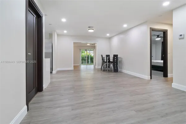 a view of a room with furniture and wooden floor