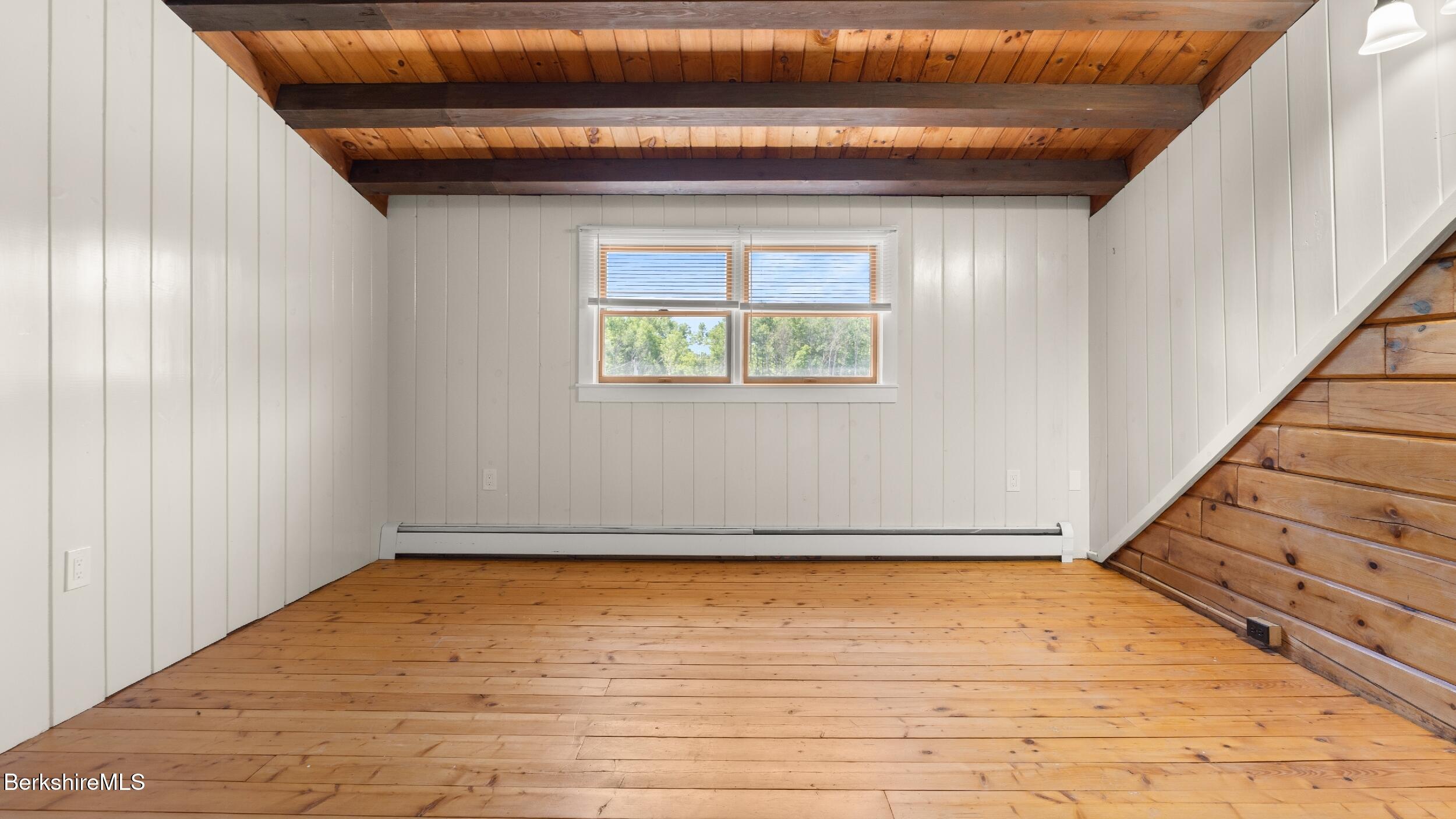 134 Hurlburt Road Great Barrington, MA 01230 - Photo 36 of 50 a view of an empty room with wooden floor and a window