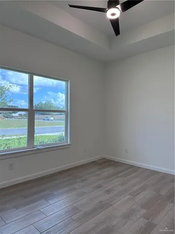 wooden floor in an empty room with a window