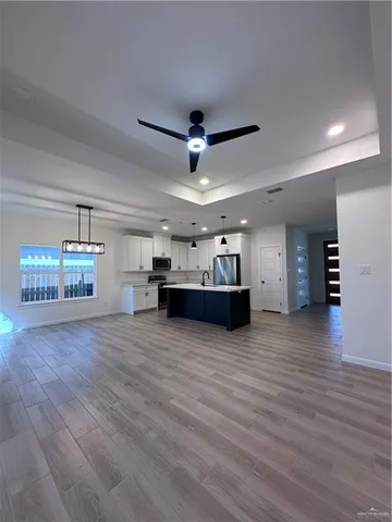 a view of a kitchen with a sink and a window