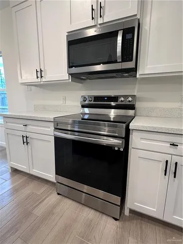 a kitchen with appliances and cabinets