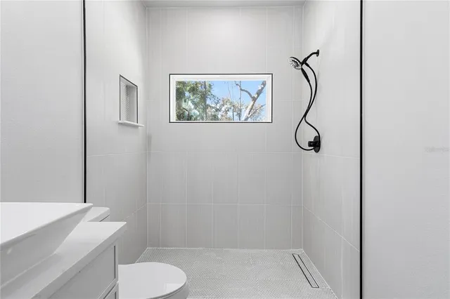 a bathroom with a toilet and a shower