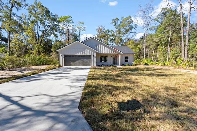 a yellow house with trees in front of it