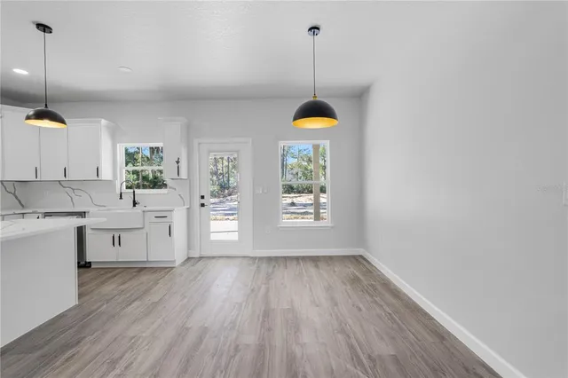 a view of a kitchen with a sink wooden floor and a wooden floor