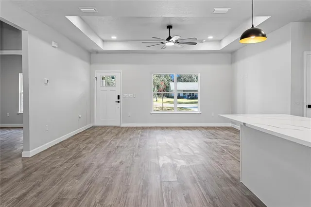 an empty room with window and wooden floor