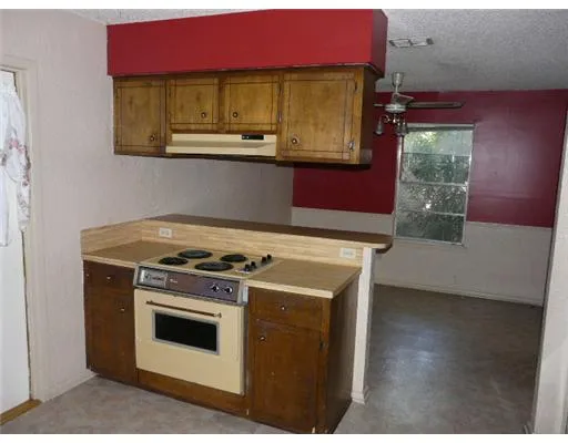 a kitchen with a stove and a microwave
